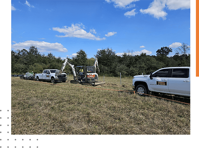 A group of trucks parked in the grass.