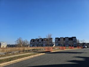 Suburban homes under a blue sky.