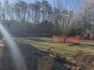 A grassy field with two red fences.