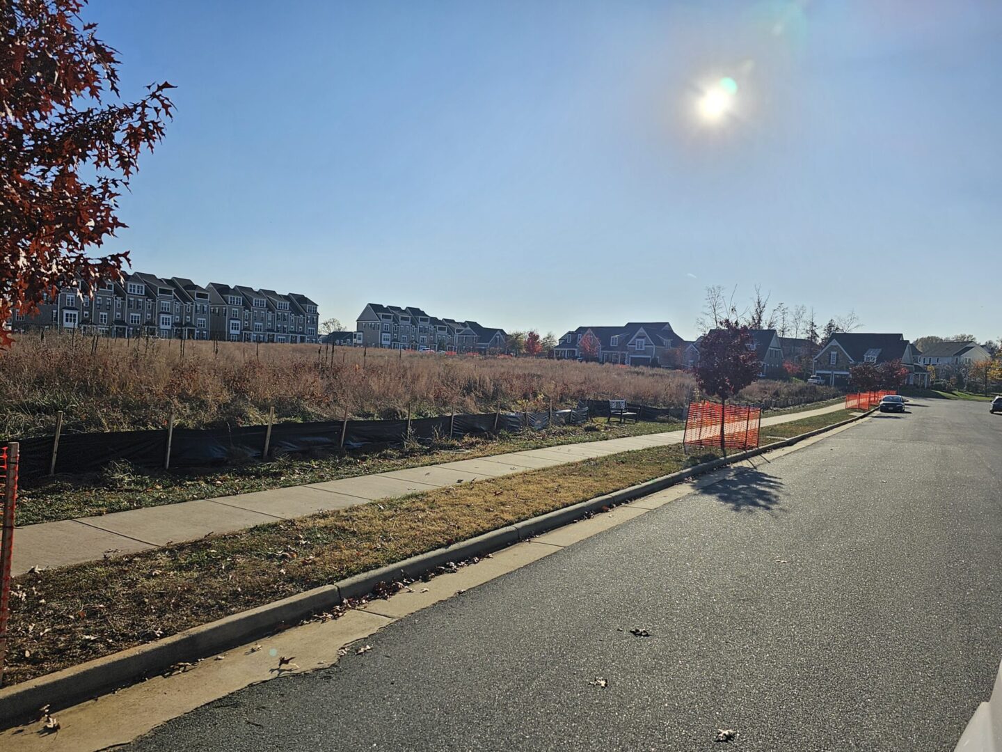 Suburban street with houses and sidewalk.