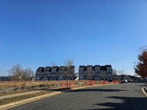 Townhouses with blue sky and a car.